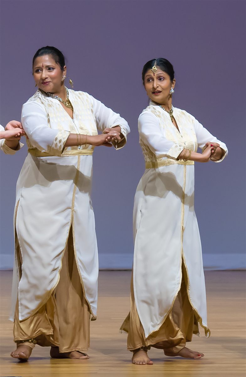 Aarti Gupta and Sapna Adhikari performing Kathak in white and gold attire on stage