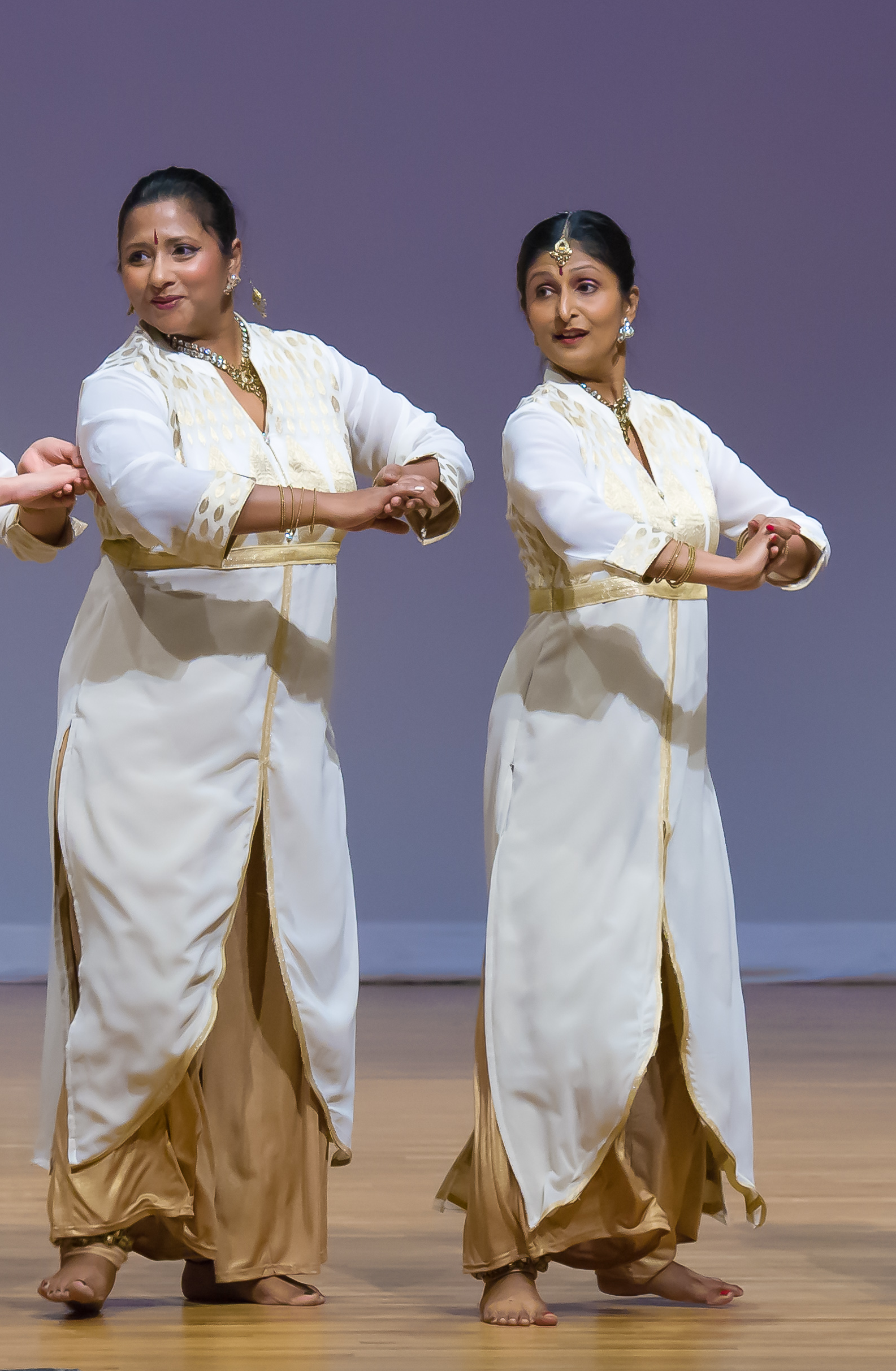 Sapna Adhikari and Aarti Gupta performing Kathak in white and gold attire on stage